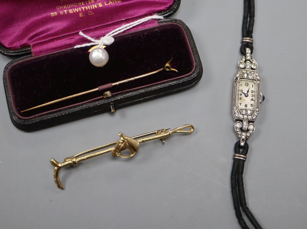 A 15ct and cultured pear dress stud, a paste set cocktail watch, a stick pin and a gilt metal riding crop brooch.